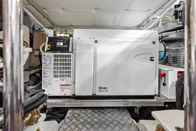 Slide: The Image of Engine room of 2023 Pershing 6X yacht featuring Onan Marine QD generator. - 56