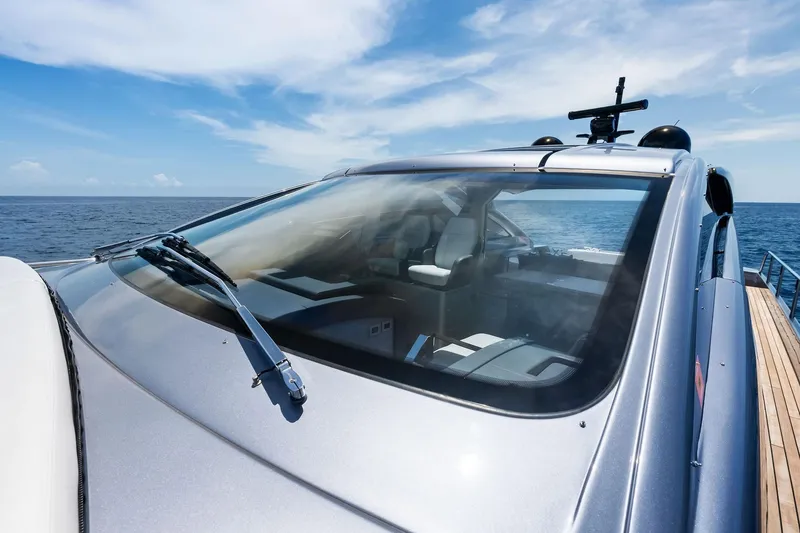 Slide: The Image of 2023 Pershing 6X yacht with sleek design, cruising on open sea under clear skies. - 32