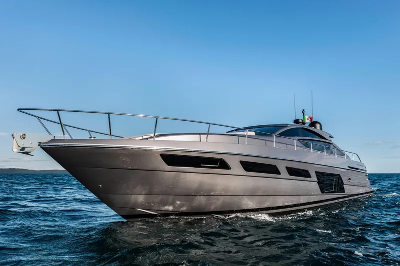 Slide: The Image of 2023 Pershing 6X yacht cruising on open water under clear blue skies. - 8