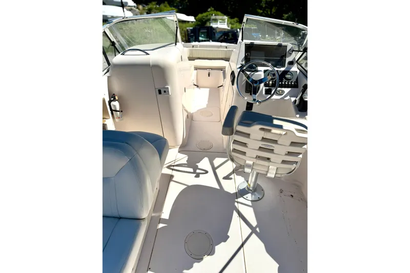 Slide: The Image of Interior view of 2005 Grady-White Freedom 225 boat, featuring steering wheel and seating. - 6