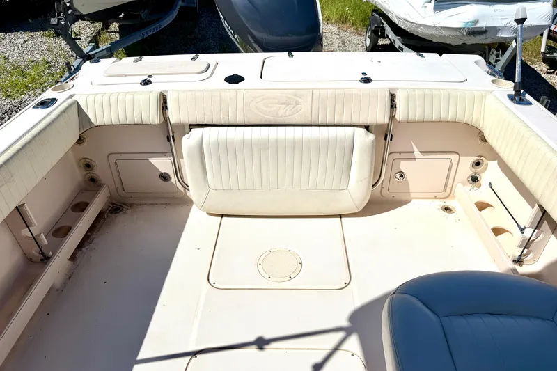Slide: The Image of 2005 Grady-White Freedom 225 boat interior with cushioned seating and storage compartments. - 3