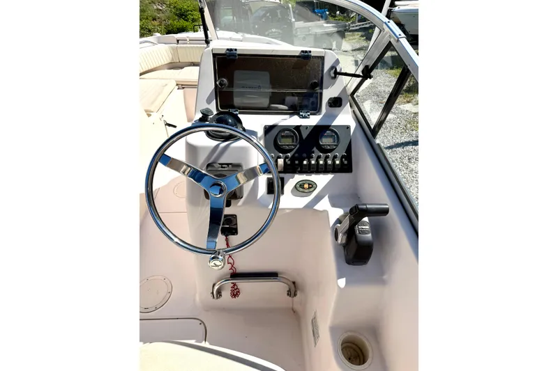 Slide: The Image of 2005 Grady-White Freedom 225 boat dashboard with steering wheel and control panel. - 5