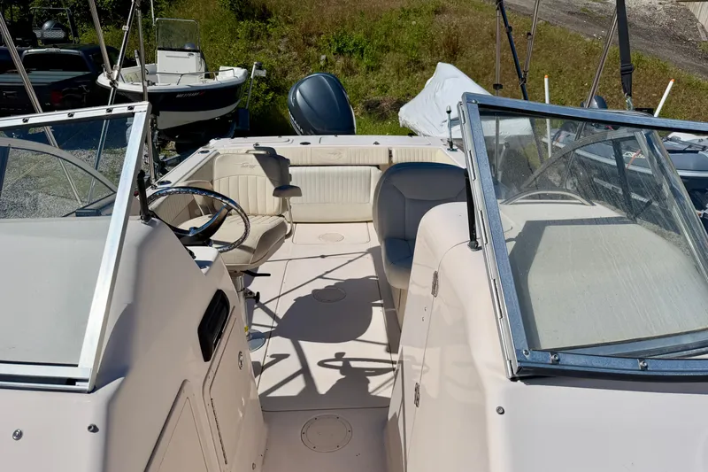 Slide: The Image of 2005 Grady-White Freedom 225 boat interior with steering wheel and seating. - 4