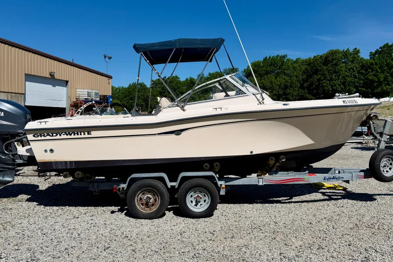 Slide: The Image of 2005 Grady-White Freedom 225 boat on trailer, parked outdoors. - 1