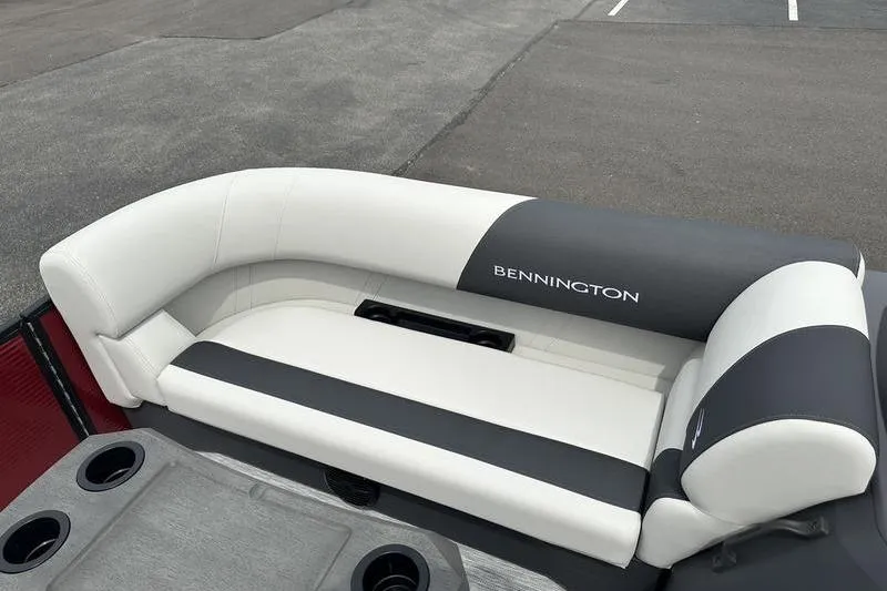 Slide: The Image of 2027 Bennington S Quad Bench 20 SSR boat seating, featuring sleek white and gray upholstery. - 17