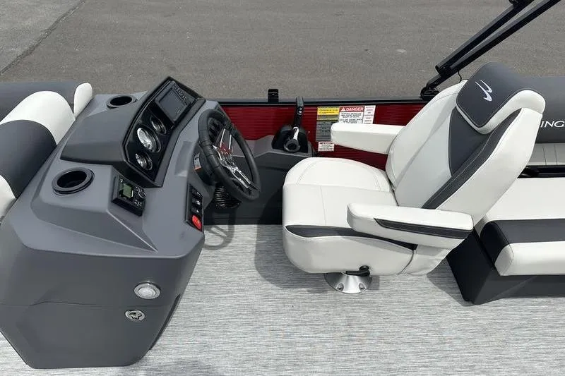 Slide: The Image of 2027 Bennington S Quad Bench 20 SSR boat interior with steering console and captain's chair. - 18