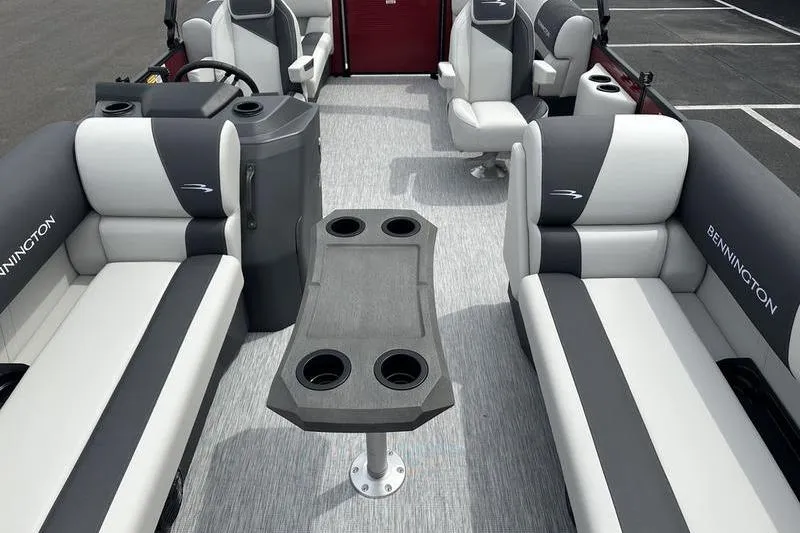 Slide: The Image of 2027 Bennington S Quad Bench 20 SSR interior with stylish seating and central table. - 14
