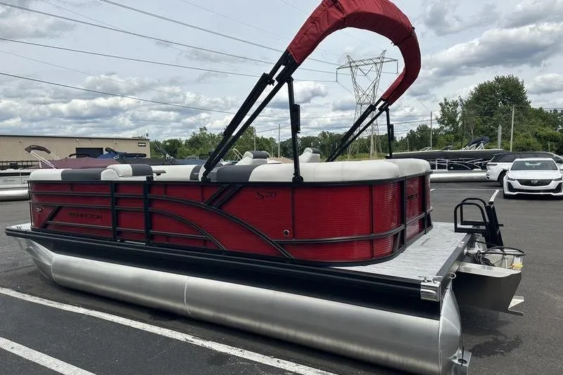 Slide: The Image of 2027 Bennington S Quad Bench 20 SSR pontoon boat with red exterior and canopy. - 11