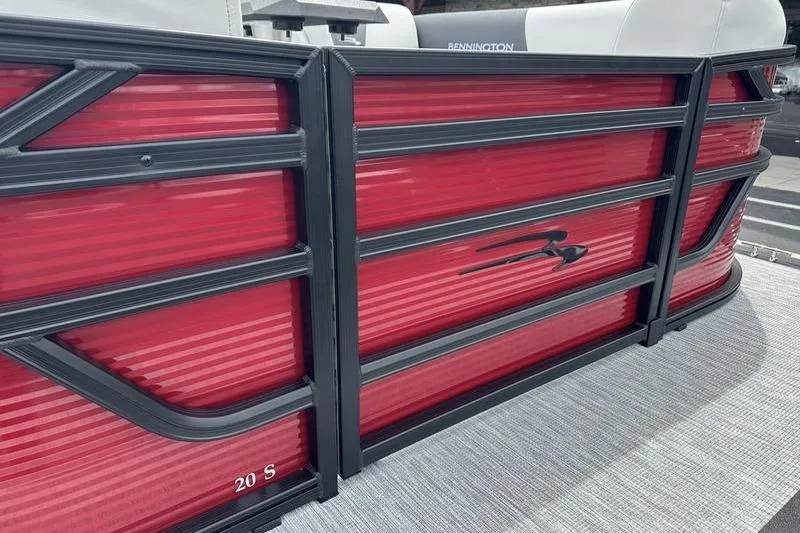 Slide: The Image of 2027 Bennington S Quad Bench 20 SSR pontoon boat with sleek red paneling and black trim. - 4