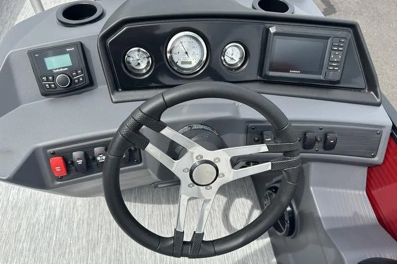 Slide: The Image of Steering console of 2027 Bennington S Quad Bench 20 SSR with gauges and controls. - 25