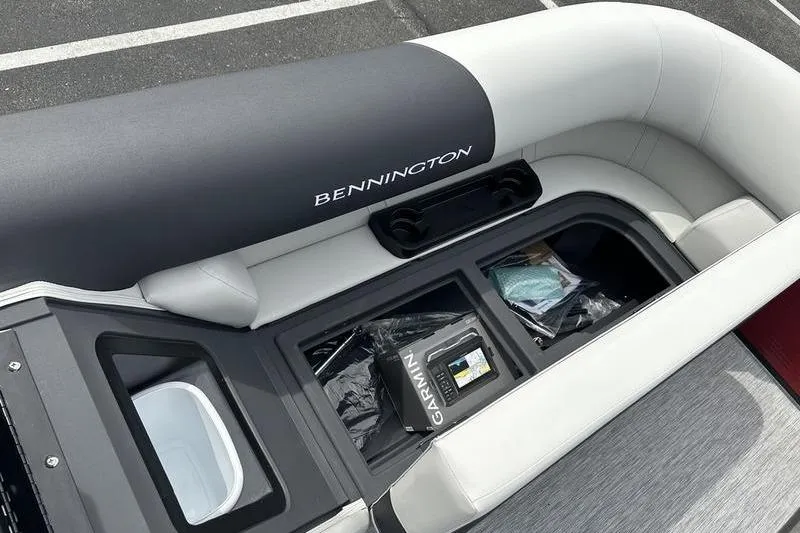 Slide: The Image of 2027 Bennington S Quad Bench 20 SSR boat interior with storage compartments and Garmin equipment. - 19