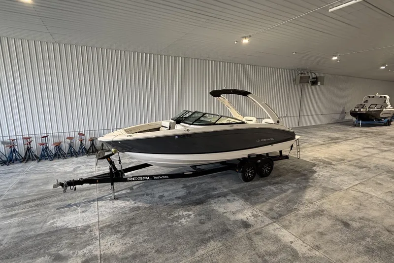 The Image of 2019 Regal LS6 boat on trailer in spacious indoor storage facility. - 0