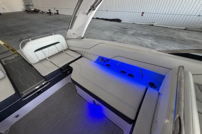 Slide: The Image of Luxurious 2019 Regal LS6 boat interior with blue LED lighting and plush seating. - 10