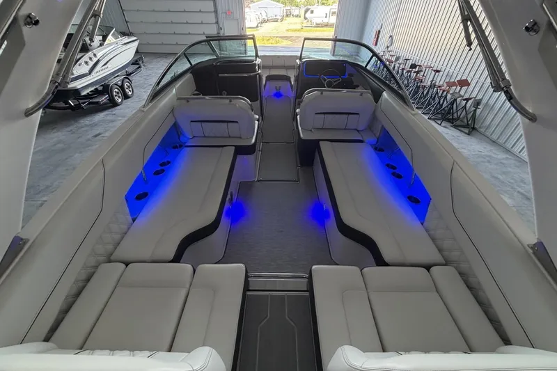 Slide: The Image of Luxurious 2019 Regal LS6 boat interior with blue LED lighting and spacious seating. - 8