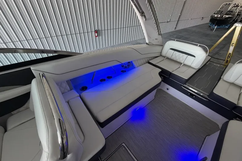 Slide: The Image of Luxurious 2019 Regal LS6 boat interior with blue LED lighting and plush seating. - 11