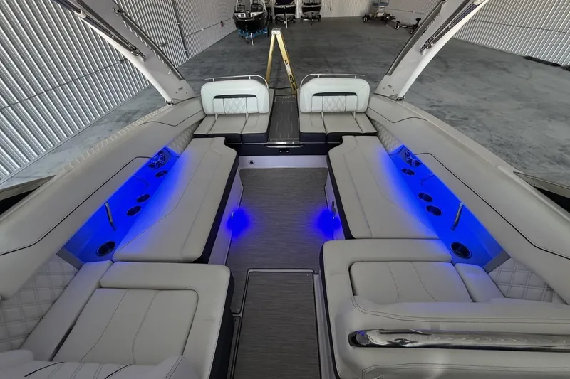 Slide: The Image of Luxurious 2019 Regal LS6 boat interior with blue LED lighting and plush seating. - 9