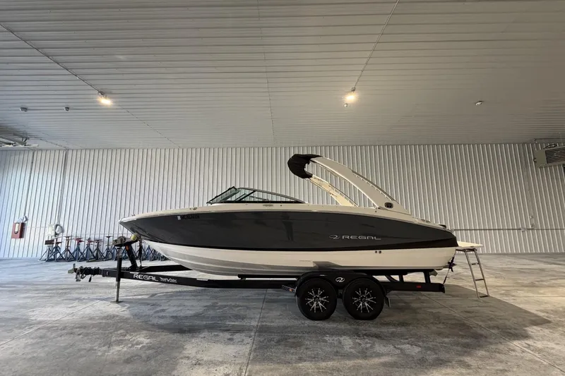 Slide: The Image of 2019 Regal LS6 boat on trailer in spacious indoor storage facility. - 2
