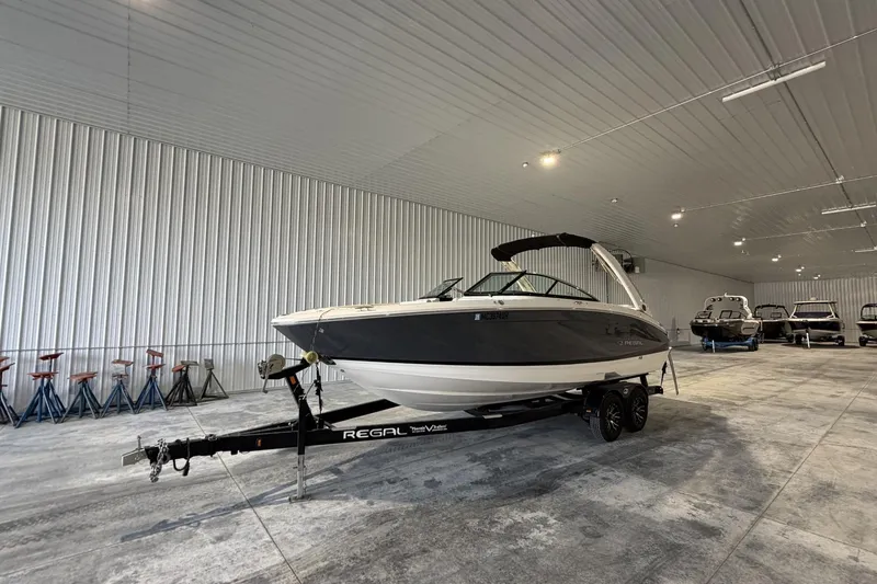 Slide: The Image of 2019 Regal LS6 boat on trailer in spacious indoor storage facility. - 1