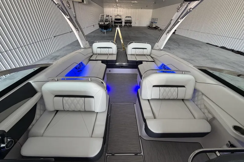 Slide: The Image of Luxurious 2019 Regal LS6 boat interior with elegant seating and ambient blue lighting. - 12