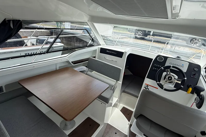 Slide: The Image of Interior of 2019 Beneteau Antares 23 boat with helm, seating, and table. - 11