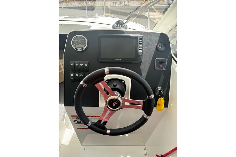 Slide: The Image of Steering console of a 2019 Beneteau Antares 23 boat with navigation controls. - 15
