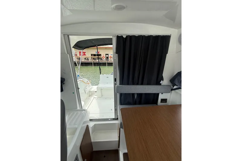 Slide: The Image of Interior view of 2019 Beneteau Antares 23, showcasing cabin and open deck area. - 17