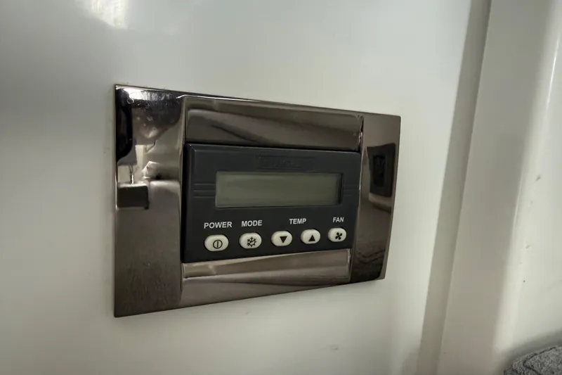 Slide: The Image of Control panel on a 2019 Beneteau Antares 23 boat, featuring power and temperature settings. - 18