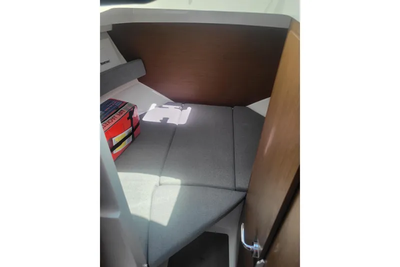 Slide: The Image of Interior cabin of 2019 Beneteau Antares 23 with cushioned seating and life jacket. - 20
