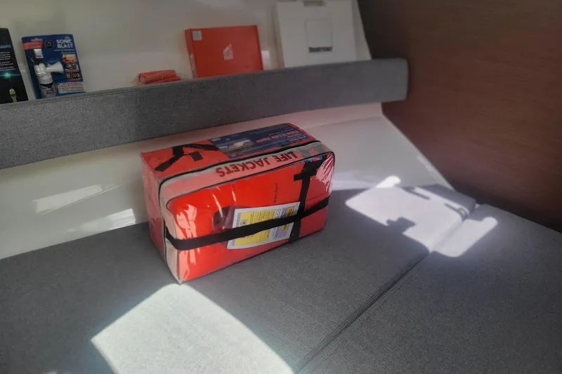 Slide: The Image of Interior of 2019 Beneteau Antares 23 with life jackets on a cushioned seat. - 21