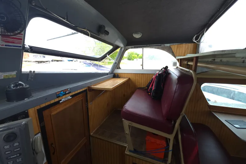 Slide: The Image of Interior of a 1974 Breaux's Bay Craft passenger boat with seating and wooden paneling. - 19