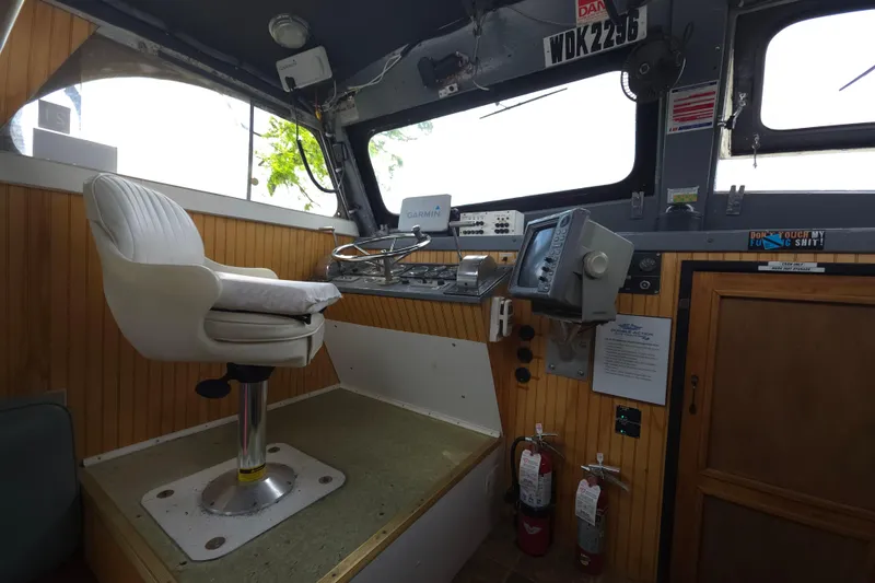 Slide: The Image of Interior of a 1974 Breaux's Bay Craft passenger boat cockpit with navigation equipment. - 20