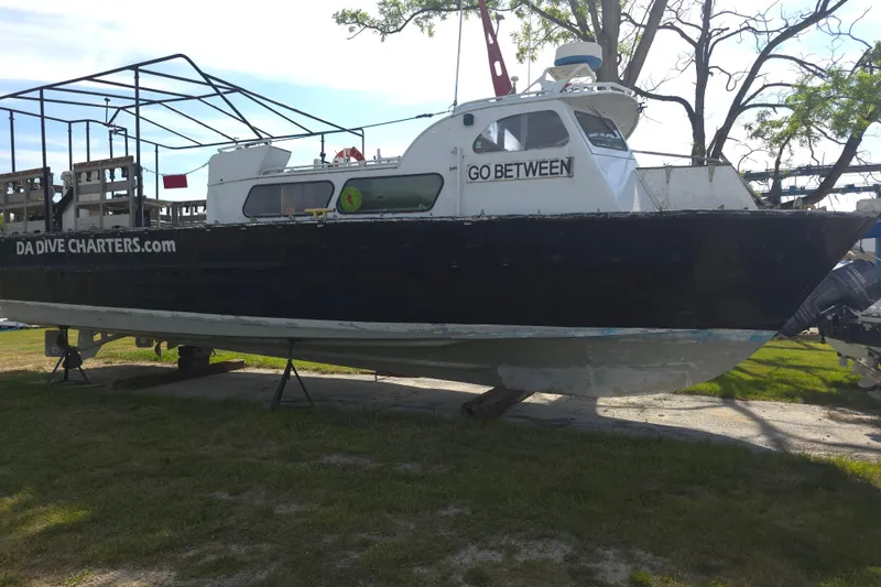Slide: The Image of 1974 Breaux's Bay Craft passenger boat "Go Between" on land, used for dive charters. - 4