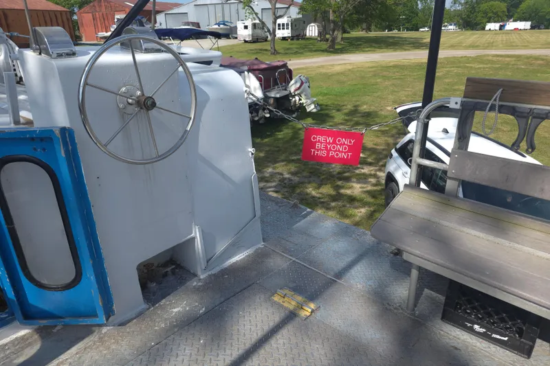 Slide: The Image of 1974 Breaux's Bay Craft boat deck with steering wheel and "Crew Only Beyond This Point" sign. - 7