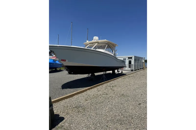 Slide: The Image of 2020 Grady-White Freedom 325 boat on display under clear blue sky. - 1