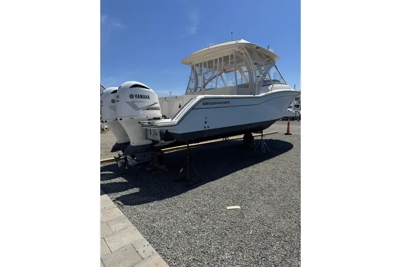 Slide: The Image of 2020 Grady-White Freedom 325 boat with Yamaha engines on display outdoors. - 2