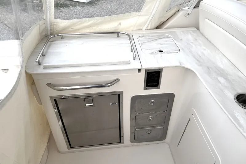 Slide: The Image of 2020 Grady-White Freedom 325 boat interior with kitchenette and storage drawers. - 14