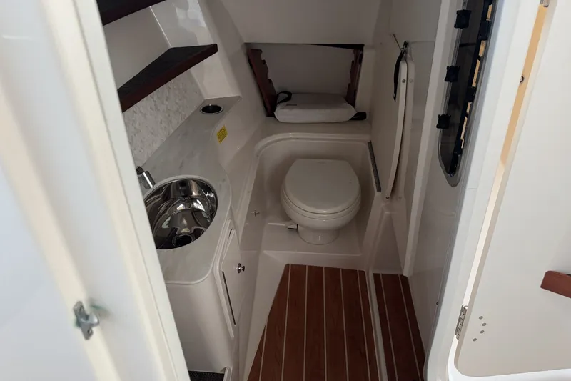 Slide: The Image of 2020 Grady-White Freedom 325 boat interior with compact bathroom and sink. - 16
