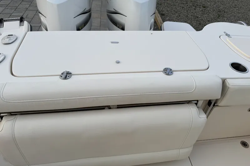 Slide: The Image of 2020 Grady-White Freedom 325 boat seating and engine area, featuring dual outboard motors. - 12