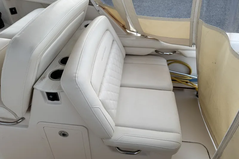 Slide: The Image of 2020 Grady-White Freedom 325 boat interior with beige seating and cup holders. - 9