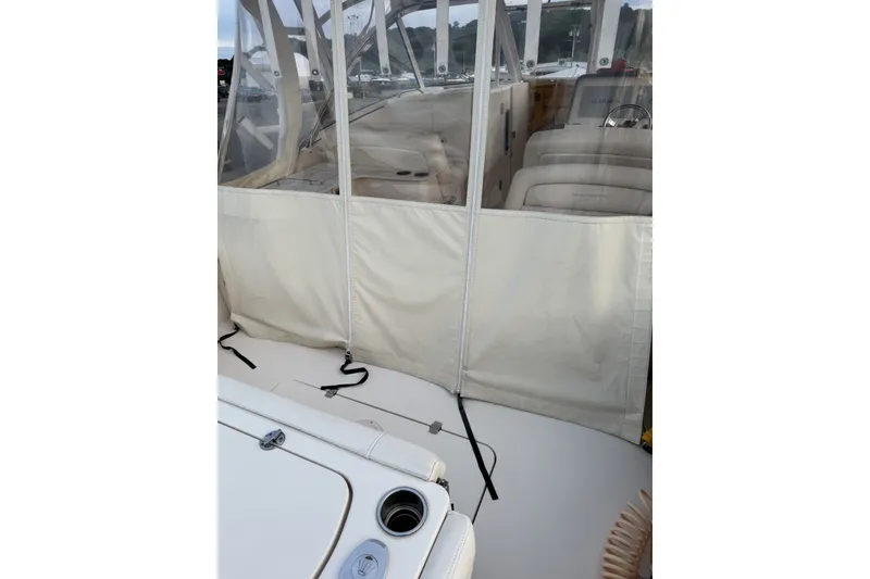 Slide: The Image of 2020 Grady-White Freedom 325 boat interior with protective cover and seating area. - 10
