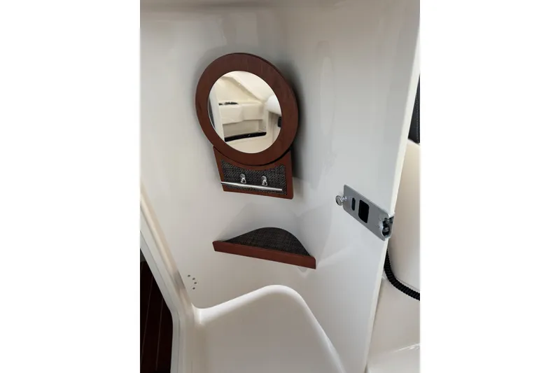 Slide: The Image of 2020 Grady-White Freedom 325 boat interior with round mirror and shelf. - 17