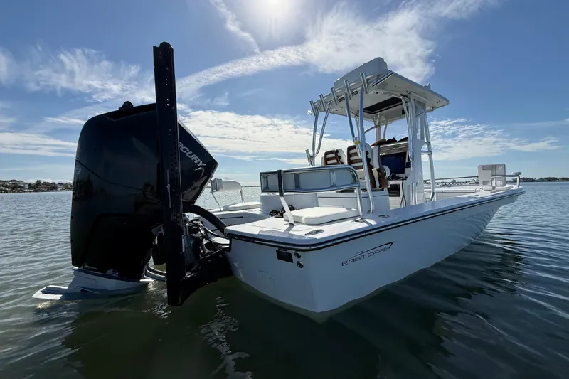 Slide: The Image of 2024 East Cape 25 Hybrid boat on calm water under a clear sky. - 10