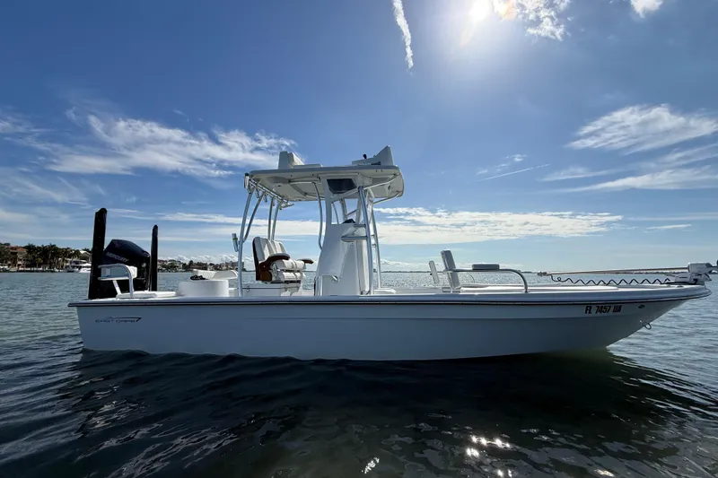 Slide: The Image of 2024 East Cape 25 Hybrid boat on calm water under a sunny sky. - 12