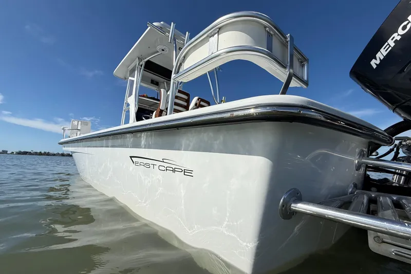 Slide: The Image of 2024 East Cape 25 Hybrid boat on water, showcasing sleek design and modern features. - 13