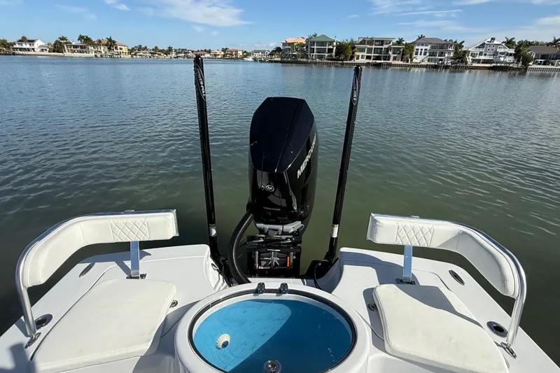 Slide: The Image of 2024 East Cape 25 Hybrid boat with Mercury engine on calm water. - 16
