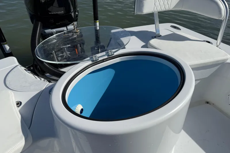 Slide: The Image of 2024 East Cape 25 Hybrid boat with open livewell and seating. - 17