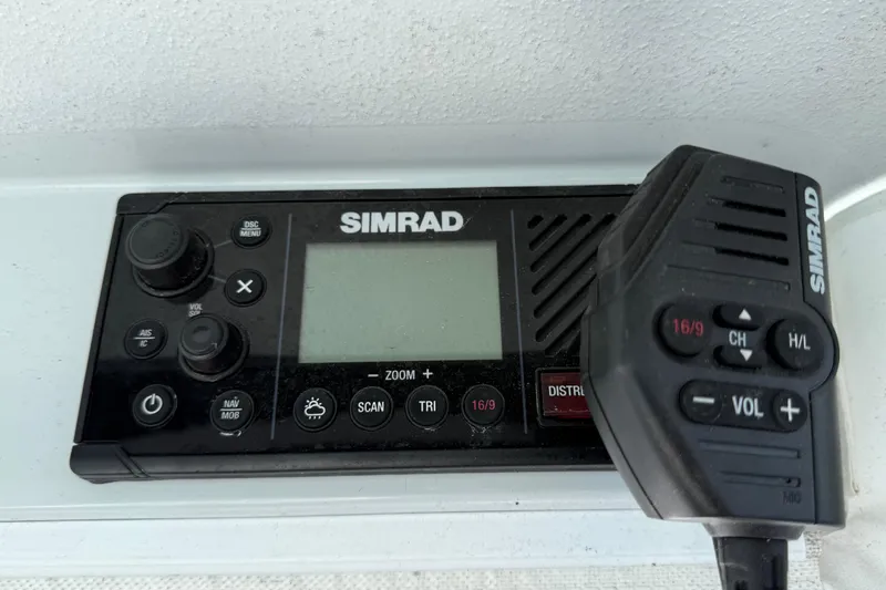 Slide: The Image of Simrad marine radio system on 2024 East Cape 25 Hybrid boat dashboard. - 27
