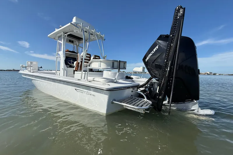Slide: The Image of 2024 East Cape 25 Hybrid boat with Mercury engine on calm water. - 3