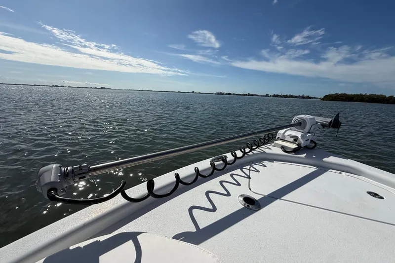 Slide: The Image of 2024 East Cape 25 Hybrid boat on calm waters under a clear blue sky. - 34