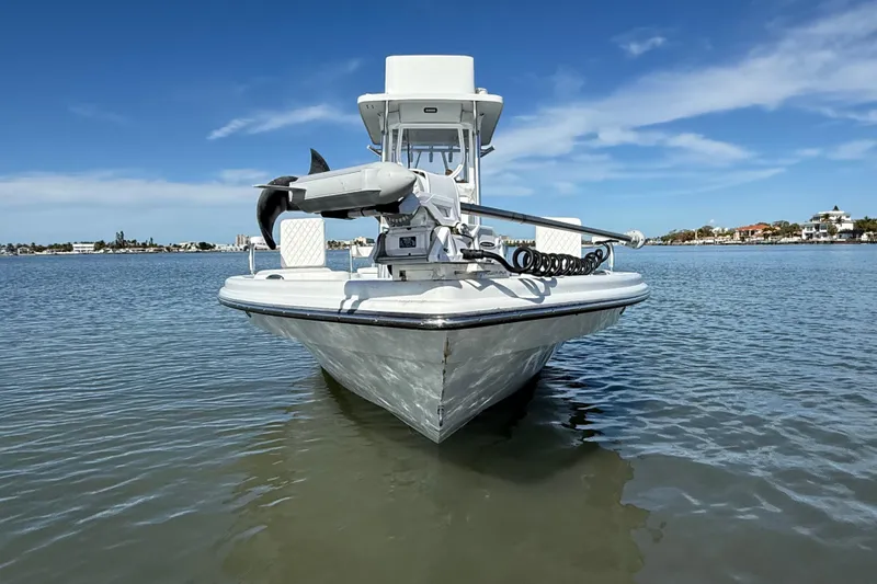 Slide: The Image of 2024 East Cape 25 Hybrid boat on calm water under clear blue sky. - 7